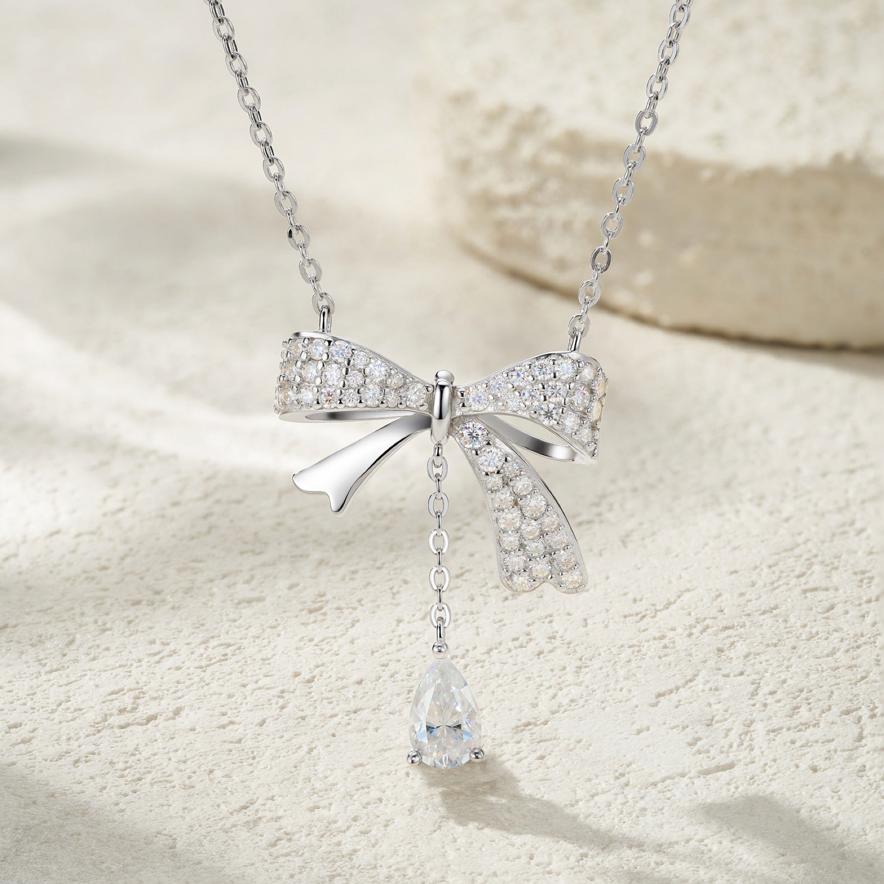 Belle Pear-Cut Moissanite Bow Pendant Necklace in Sterling Silver