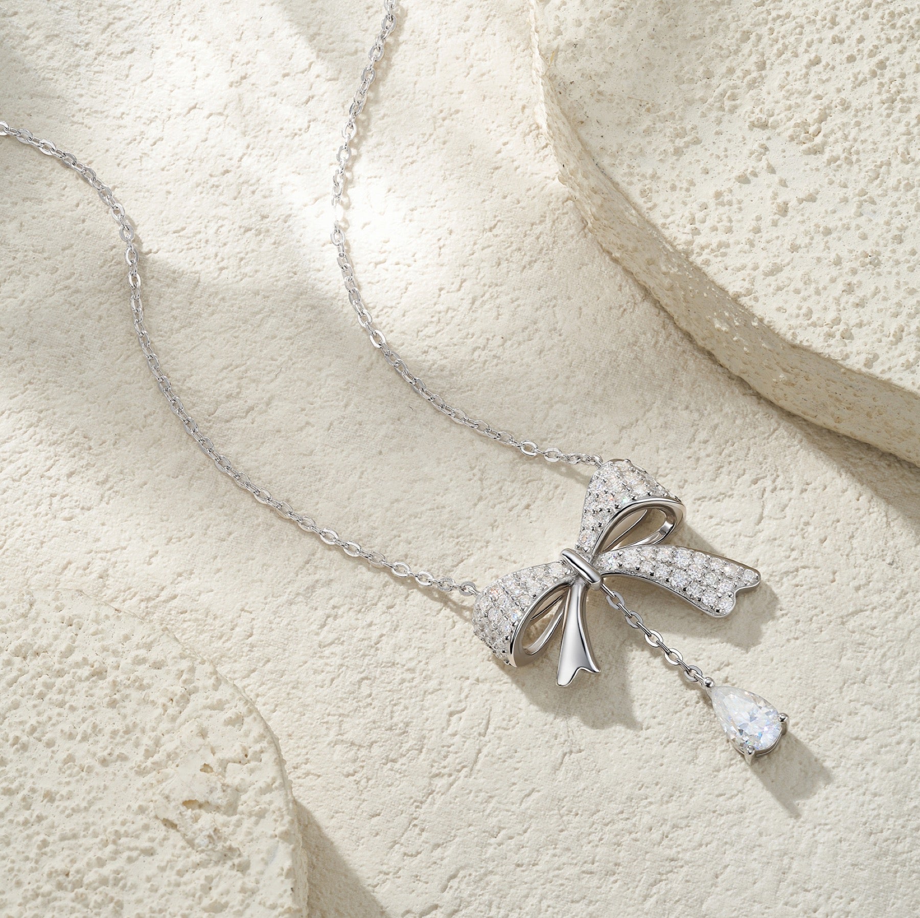 Belle Pear-Cut Moissanite Bow Pendant Necklace in Sterling Silver
