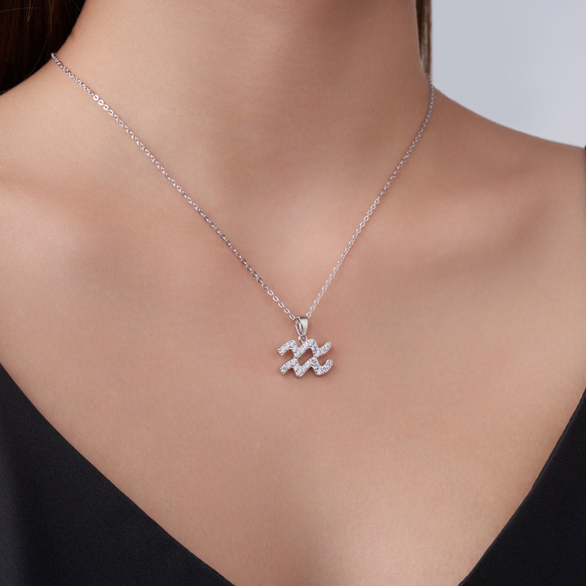 Aquarius Moissanite Zodiac Pendant Necklace in Sterling Silver, shown worn