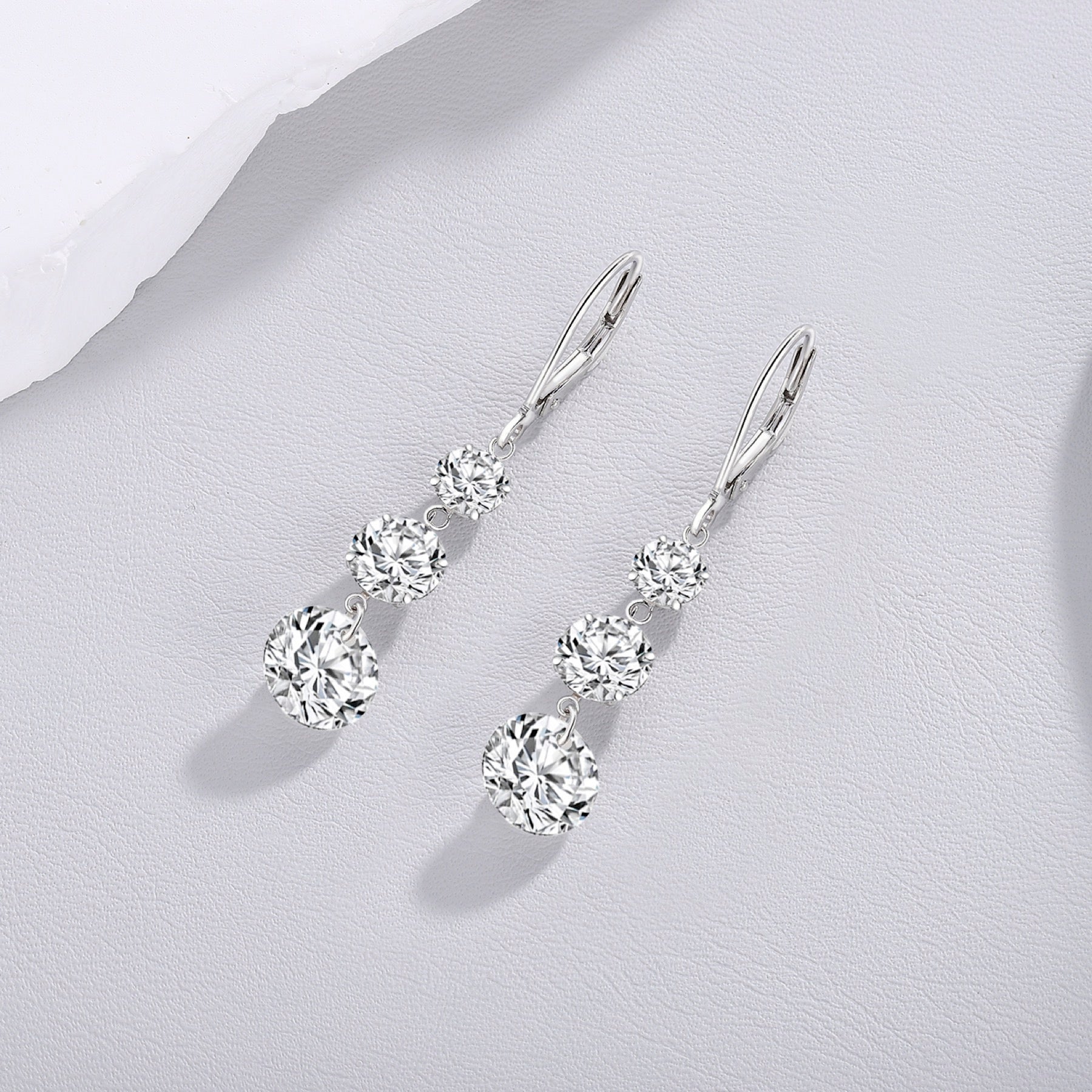 Graduate Moissanite Three-Stone Drop Earrings in Sterling Silver