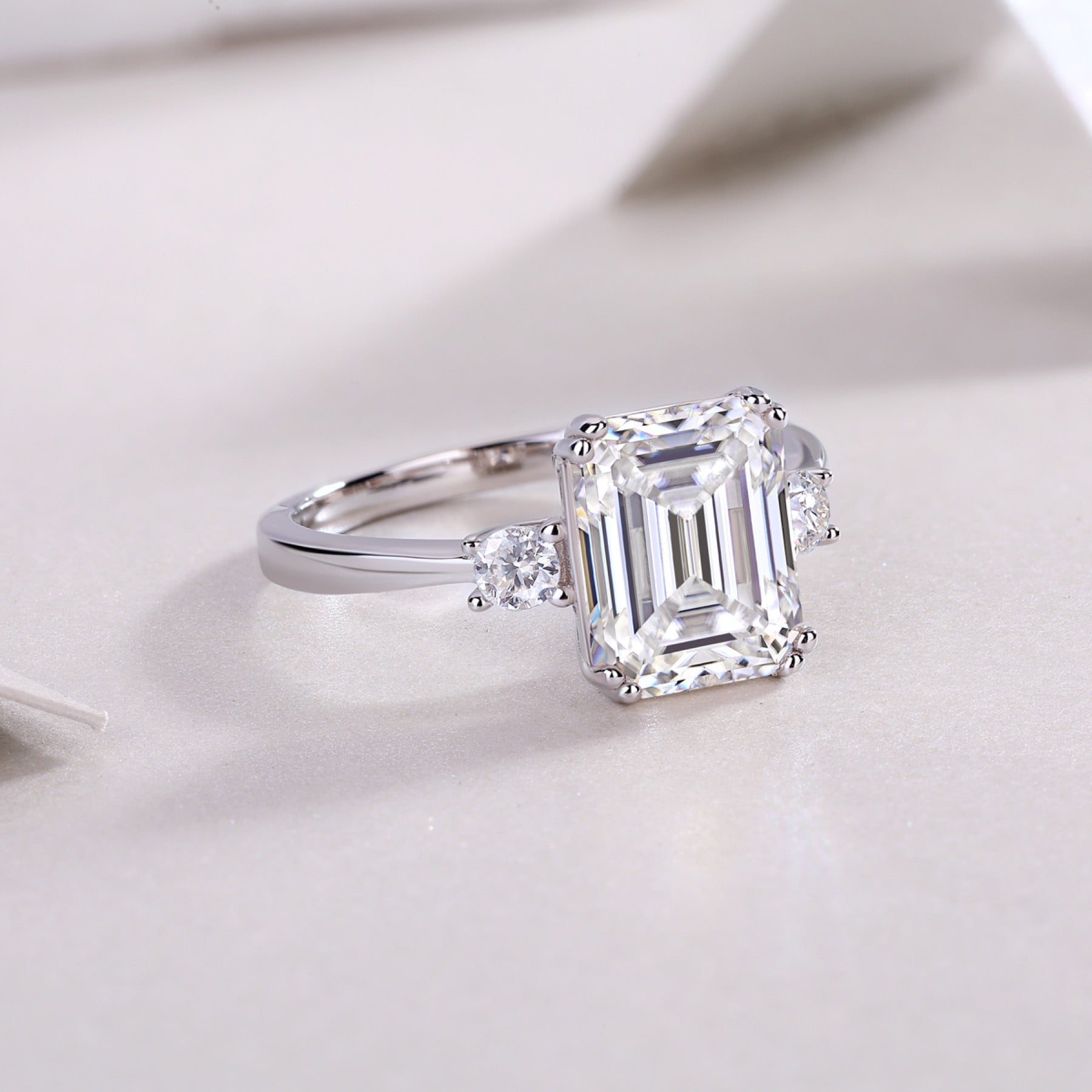 Token Emerald-Cut Moissanite Three-Stone Ring in Sterling Silver