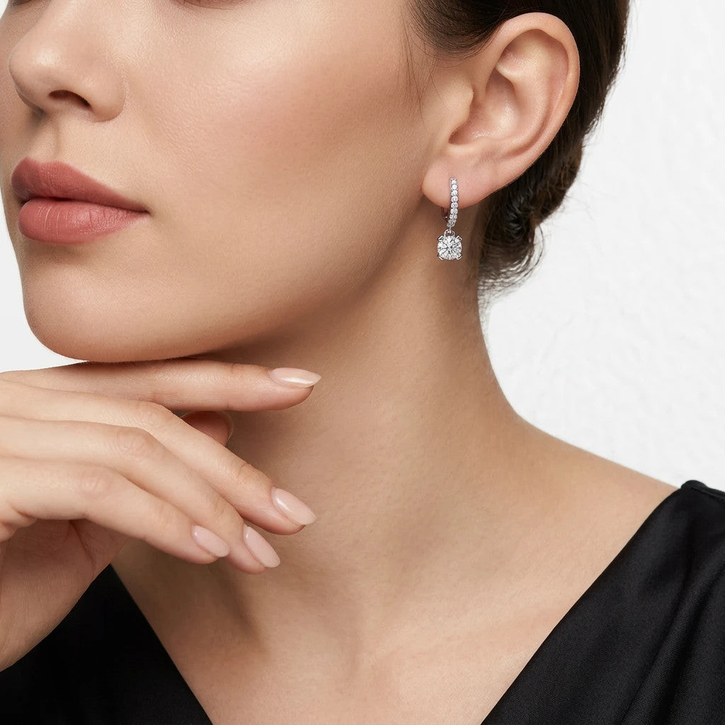 Altalena 0.5 Carat Moissanite Drop Huggie Earrings in Sterling Silver, shown worn