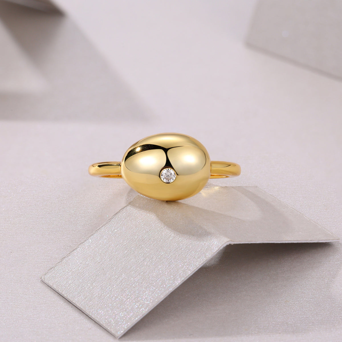 Muschio Moissanite Pebble Ring in Gold-Tone Sterling Silver, styled product photo
