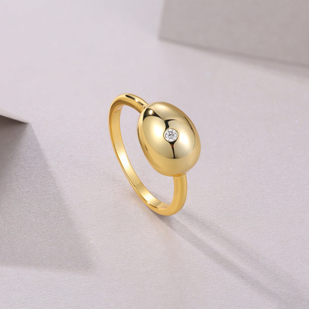 Muschio Moissanite Pebble Ring in Gold-Tone Sterling Silver, styled product photo