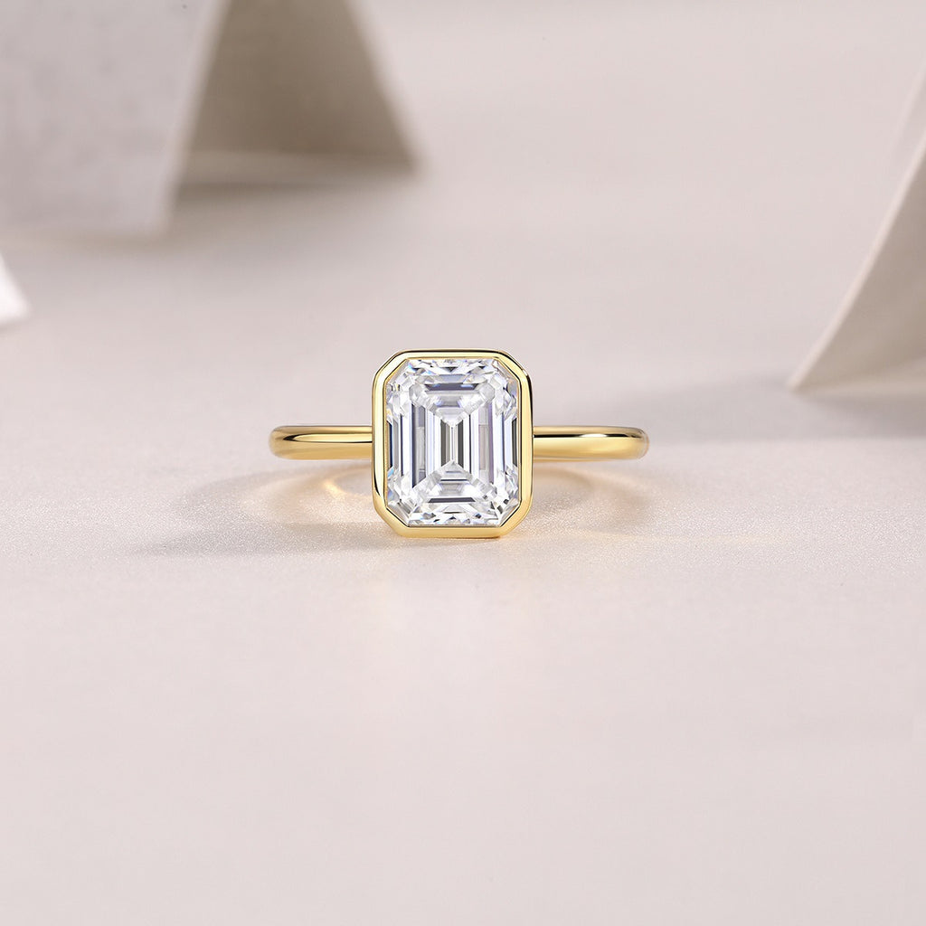 Mirador 3 Carat Emerald-Cut Moissanite Bezel Ring in Gold-Tone Sterling Silver, styled product photo