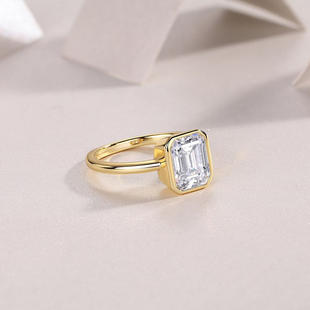 Mirador 3 Carat Emerald-Cut Moissanite Bezel Ring in Gold-Tone Sterling Silver, styled product photo