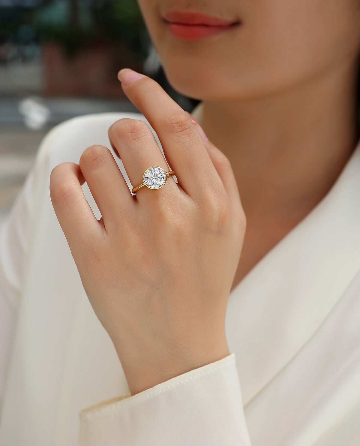 Ora 3 Carat Moissanite Bezel Solitaire Ring in Gold-Tone Sterling Silver, shown worn