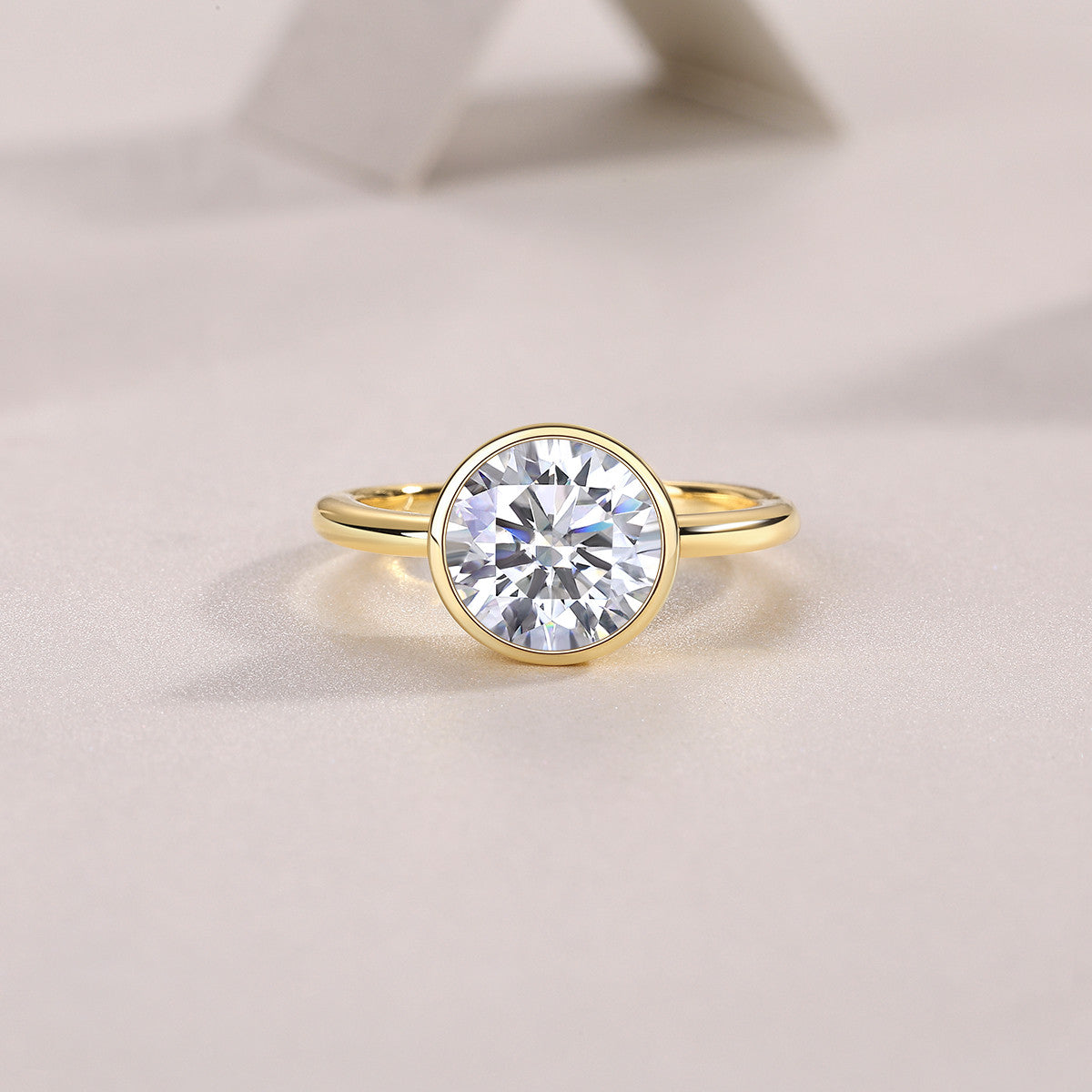 Ora 3 Carat Moissanite Bezel Solitaire Ring in Gold-Tone Sterling Silver, styled product photo
